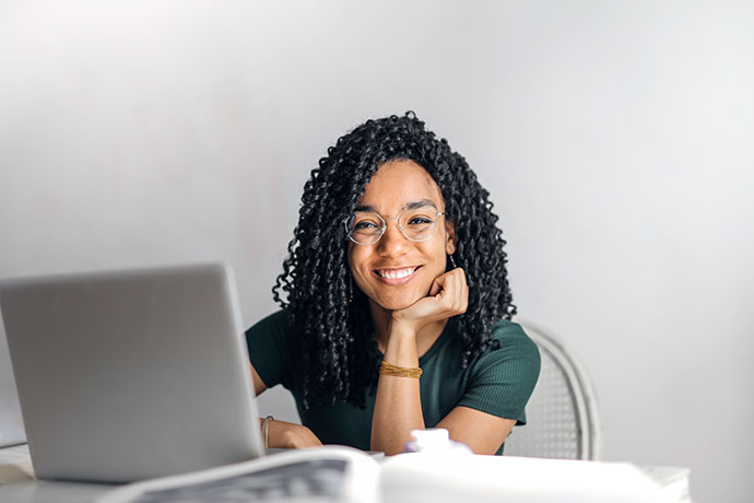 women smiling while at a computer